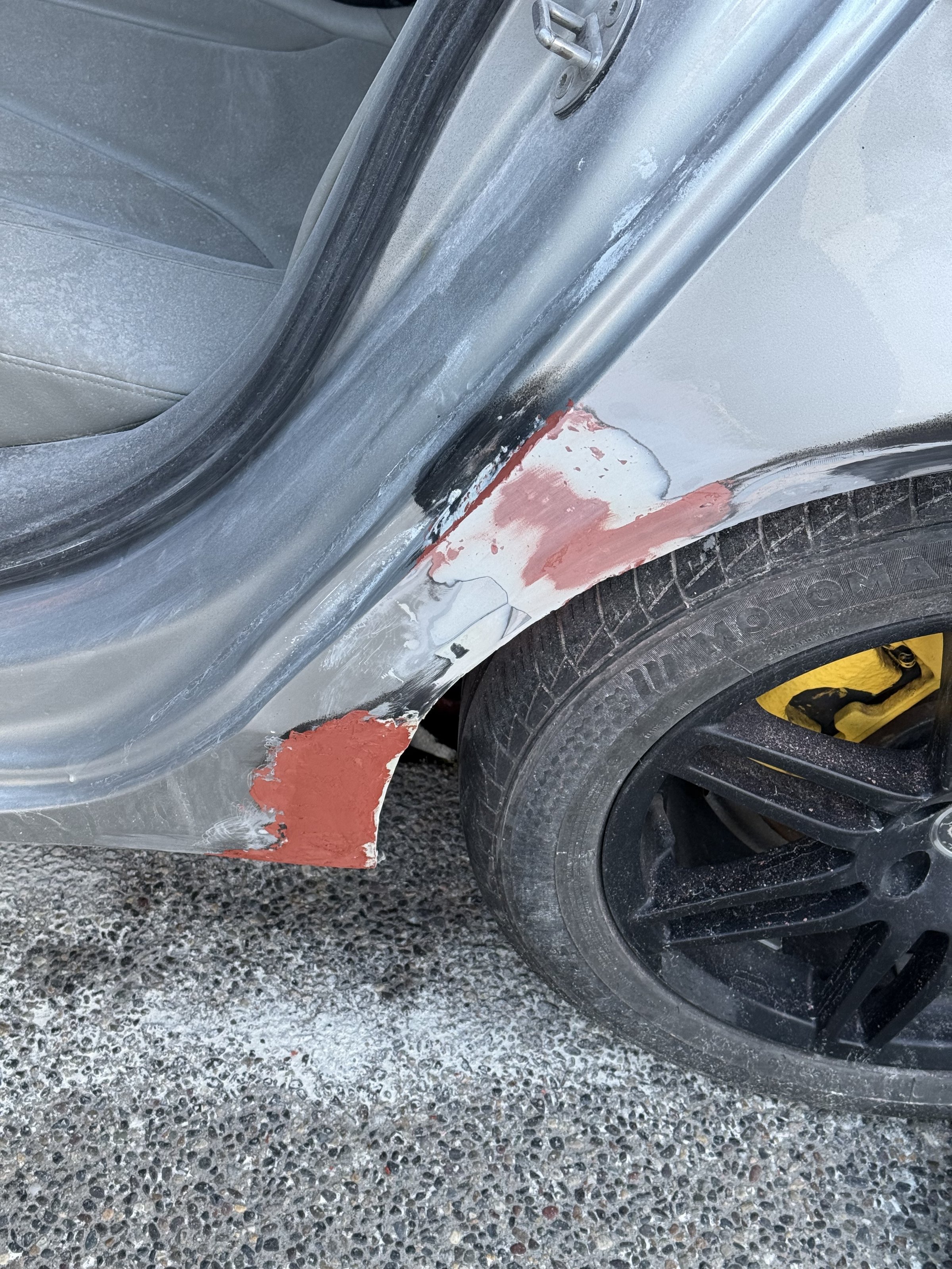 Prepared areas around the open rear door and wheel arch